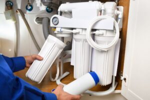 A man in South Kansas City holds a water filter.